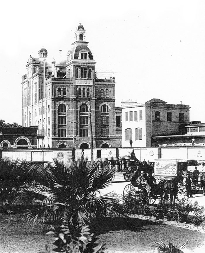 A black and white picture of Pearl’s Brewhouse building that was built in 1894. Now, this building is where the Hotel Emma resides.