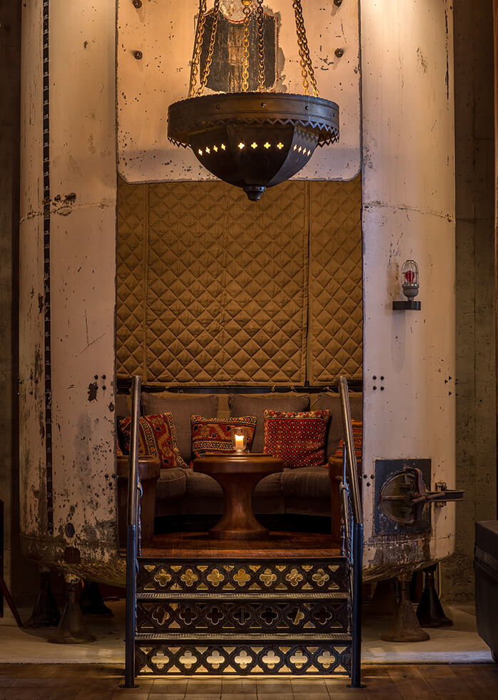 Image of Hotel Emma's bar and clubroom intimate seating with 25-foot vaulted ceilings.